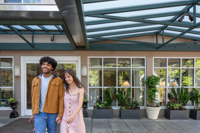 couple standing outside portland hotel
