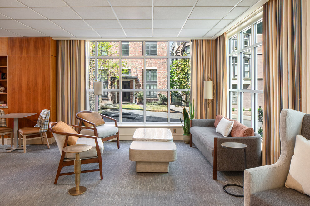 a room with a couch and chairs