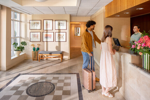 People Checking In at Front Desk