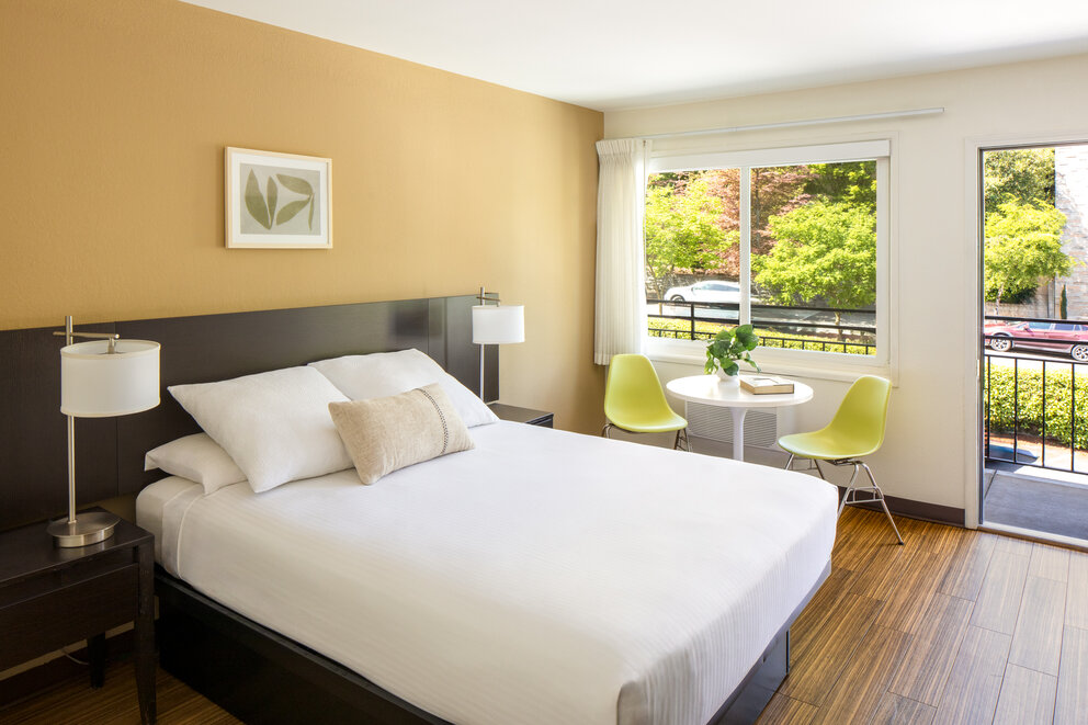 a bedroom with a bed and a table and chairs
