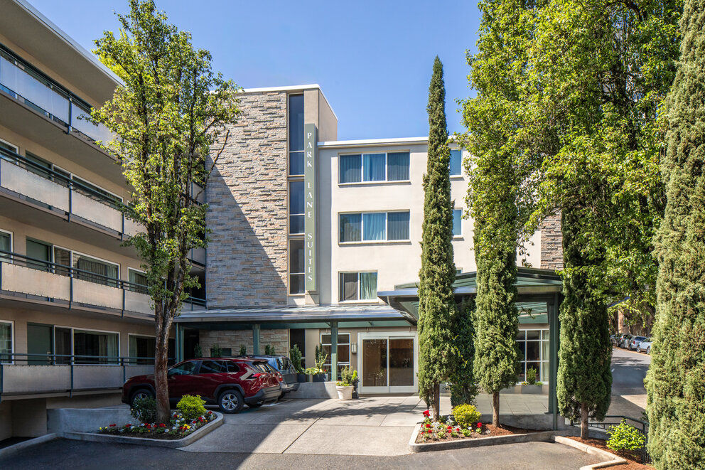 a building with trees and a parking lot
